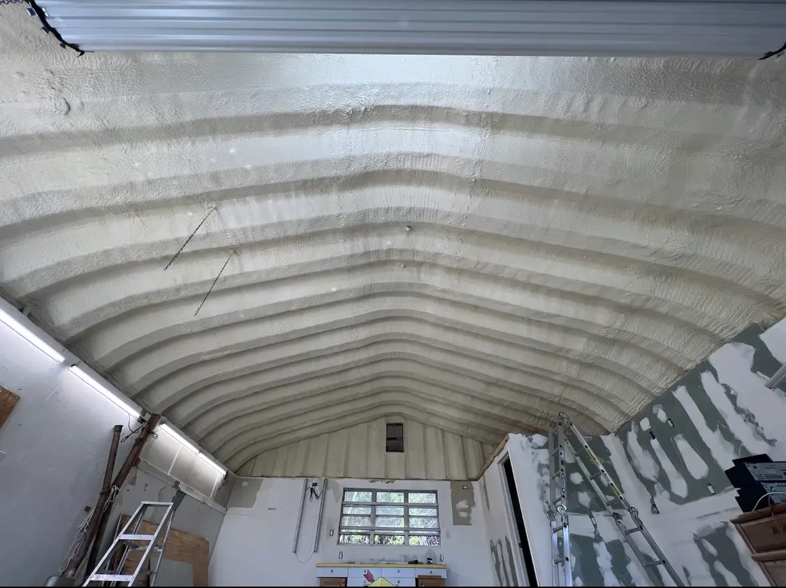 Spray polyurethane foam applied to the underside of a metal roof deck in Lawrence